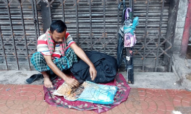 বৃষ্টি বাড়লেও অলস সময় ছাতা মেরামতকারীদের